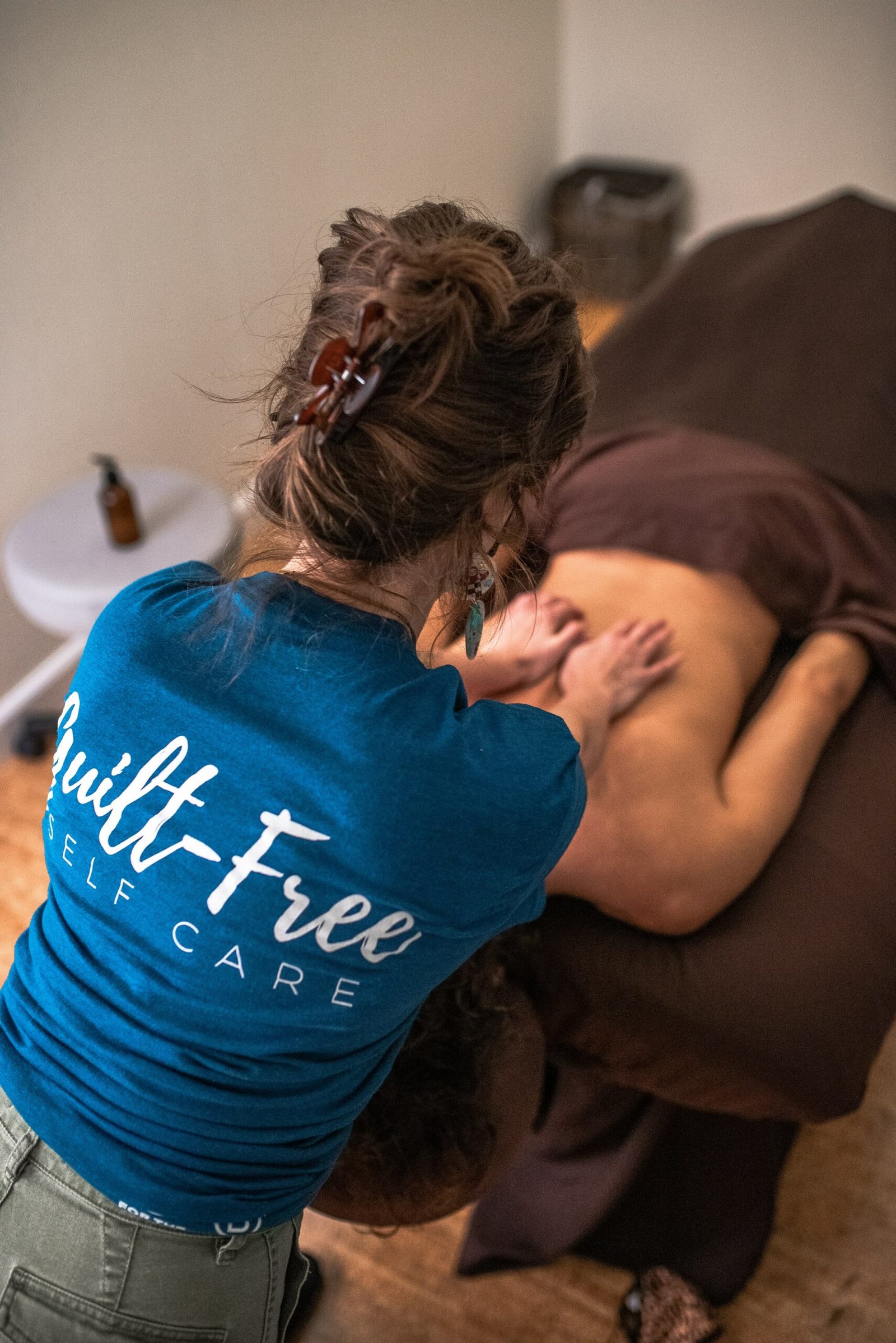 Sloco Massage Therapist massaging a guest's back