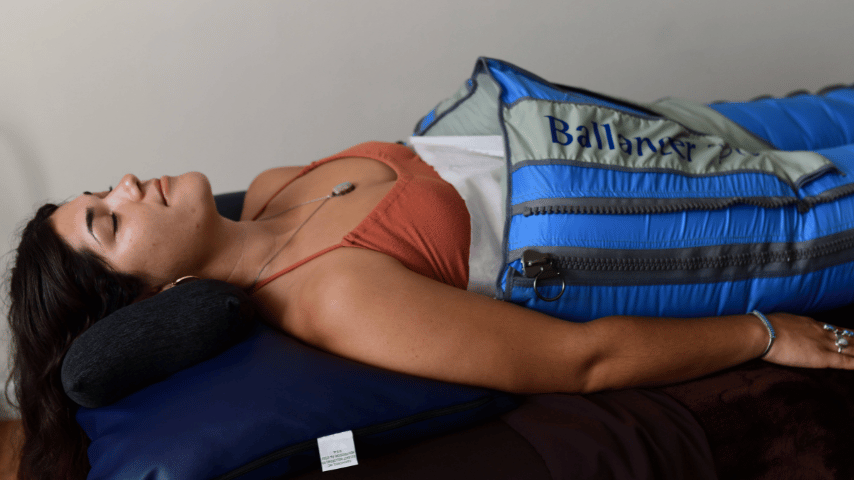 Massage Therapist at Sloco Massage + Wellness giving a hot stone massage