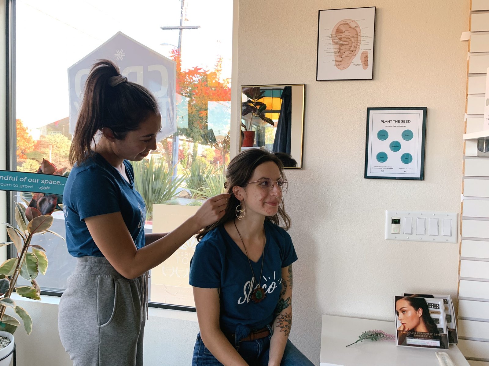 Sloco Wellness Advocate applying acupressure ear seeds in San Luis Obispo
