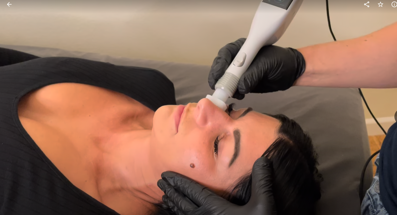 Massage Therapist at Sloco Massage + Wellness giving a hot stone massage