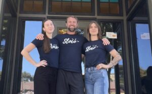 Three members of our team at Sloco Massage + Wellness standing together and smiling.